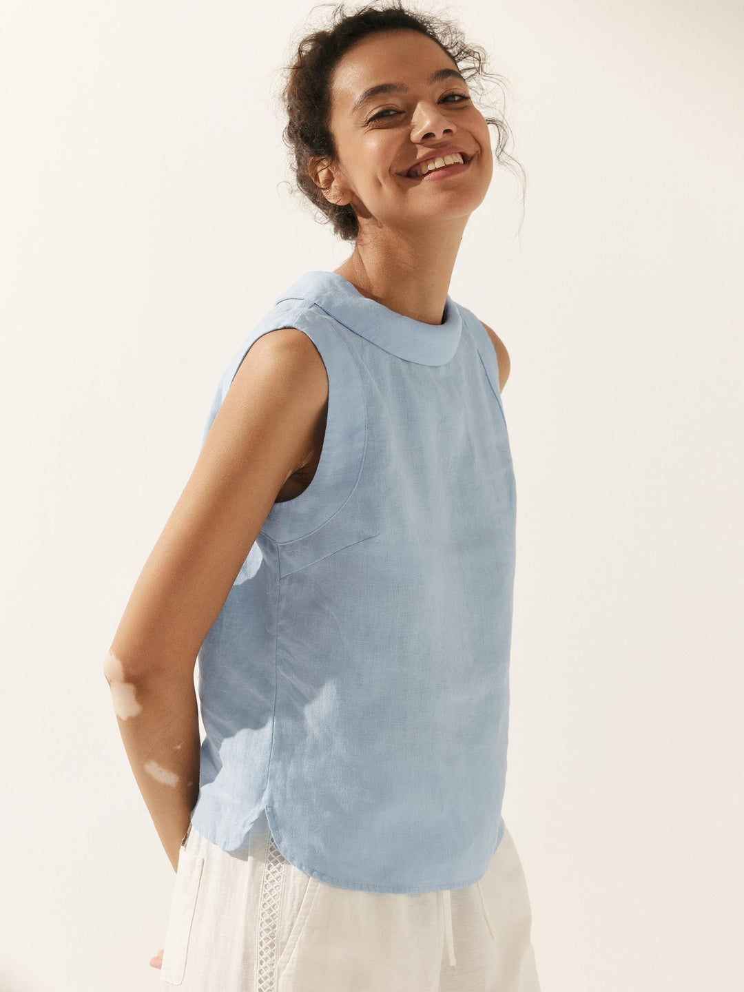 Women’s Sleeveless Top with High Neck and Structured Collar